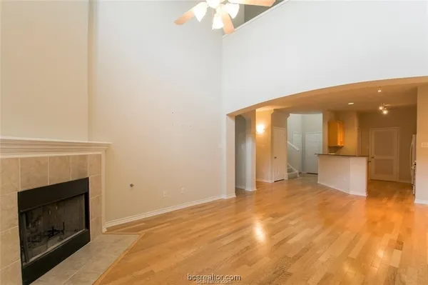 a view of an empty room with a fireplace and a window
