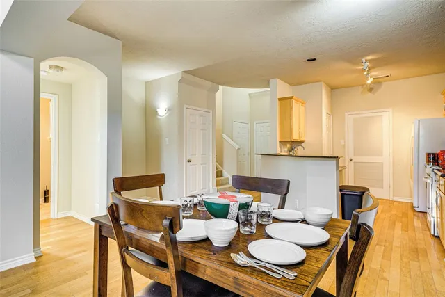 a dining room with furniture and wooden floor