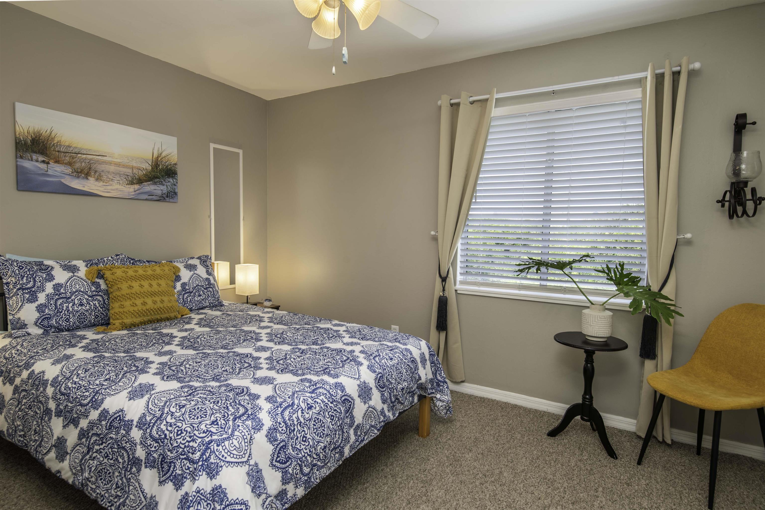 6452 Madison Street St. Augustine, FL 32080 - Photo 13 of 27 a bedroom with a large bed and a window