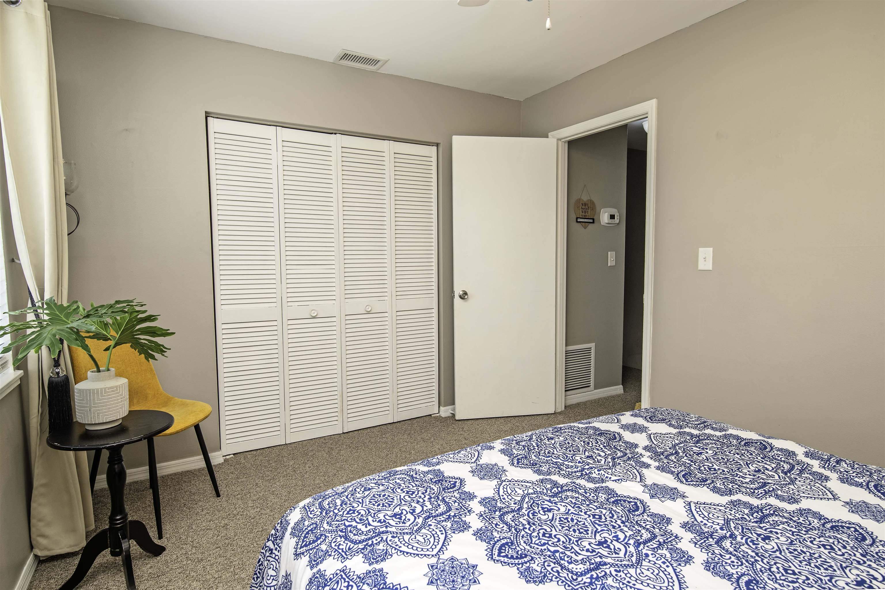 6452 Madison Street St. Augustine, FL 32080 - Photo 14 of 27 a bedroom with a bed and a potted plant