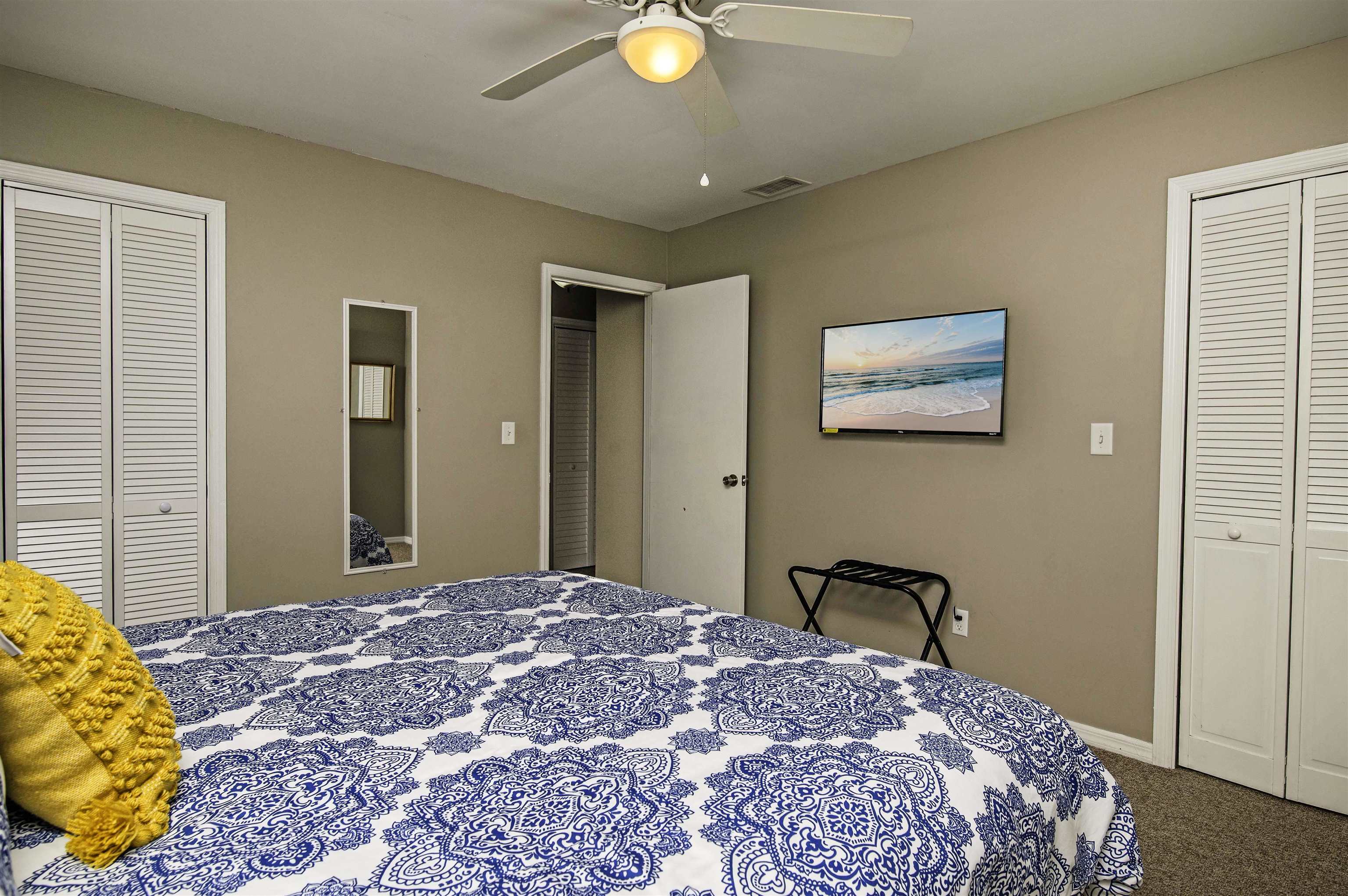 6452 Madison Street St. Augustine, FL 32080 - Photo 17 of 27 a bedroom with a bed and a chandelier