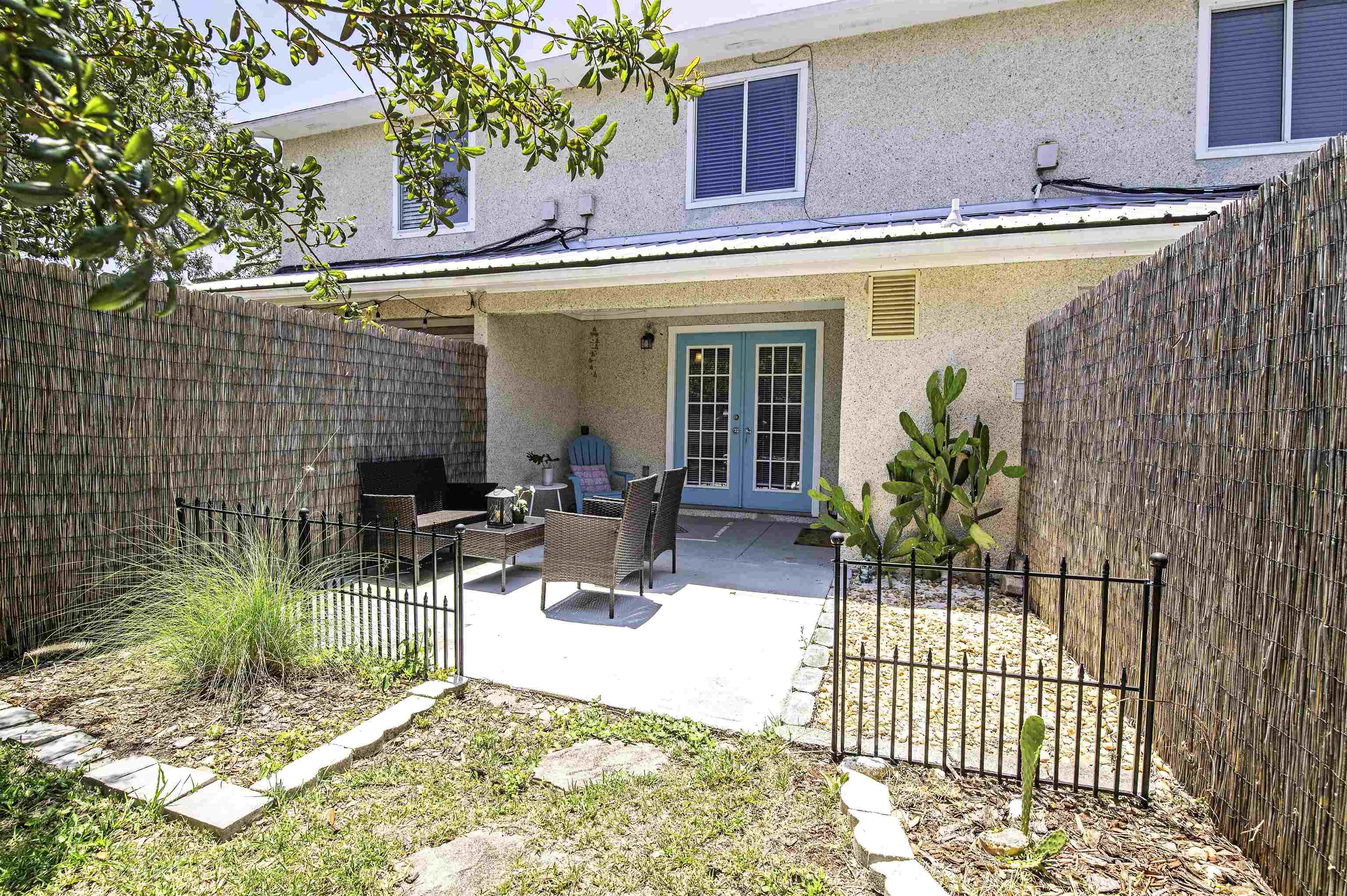 6452 Madison Street St. Augustine, FL 32080 - Photo 20 of 27 a view of a patio with couches table and chairs and potted plants