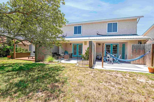 a house view with a sitting space and garden