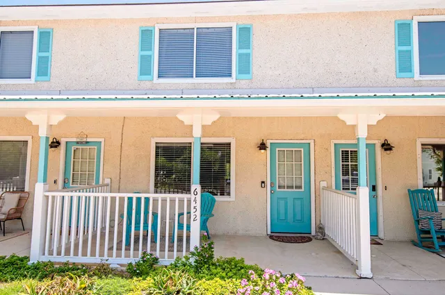 a view of a balcony with a floor to ceiling window and wooden floor