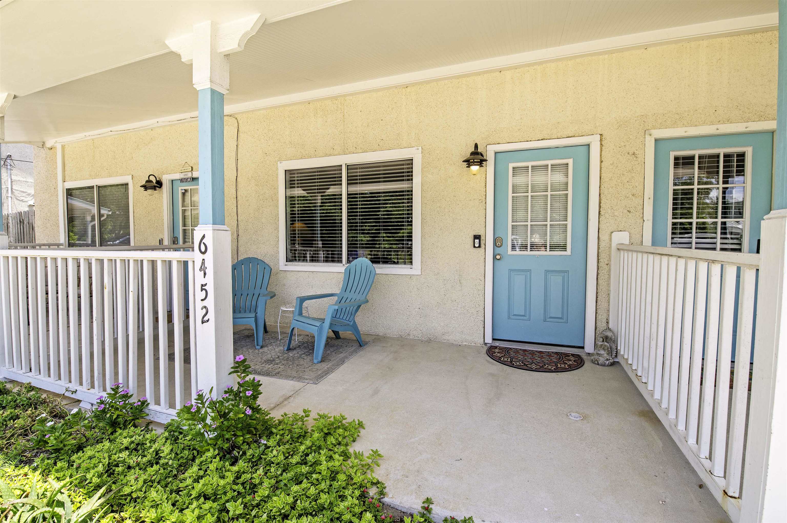 6452 Madison Street St. Augustine, FL 32080 - Photo 4 of 27 a front view of a house with outdoor seating and plants
