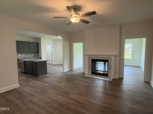 a view of a kitchen with a sink and a fireplace