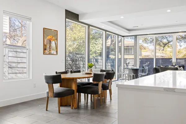 a view of a dining room with furniture large windows and wooden floor