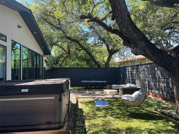 a view of swimming pool with outdoor seating and plants