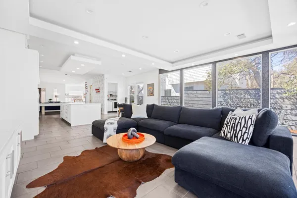 a living room with furniture and view of kitchen