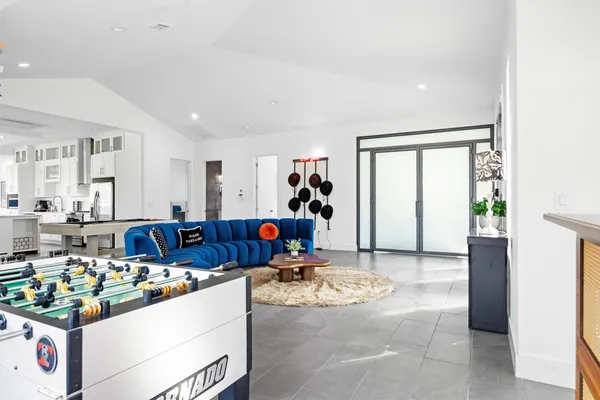 a living room with furniture and a chandelier