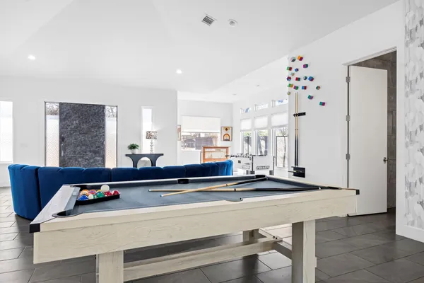 a living room with stainless steel appliances kitchen island granite countertop furniture and a large window