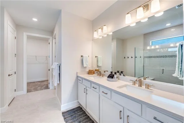 a bathroom with a double vanity sink a mirror and a shower