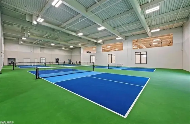 a room with pool table and window