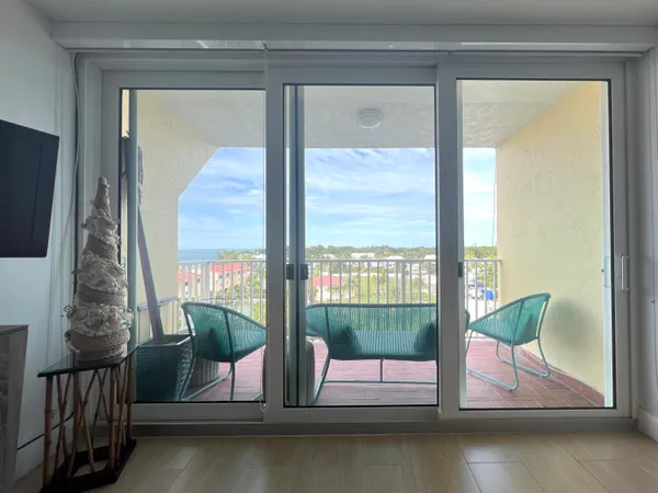 a bedroom with a bed and a lamp on dresser