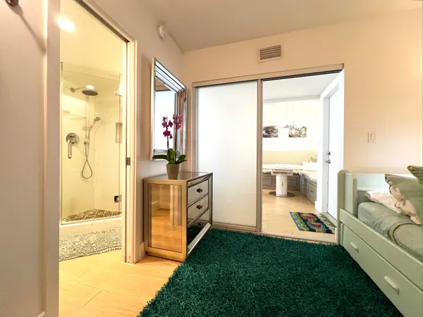 a bathroom with a toilet and a shower