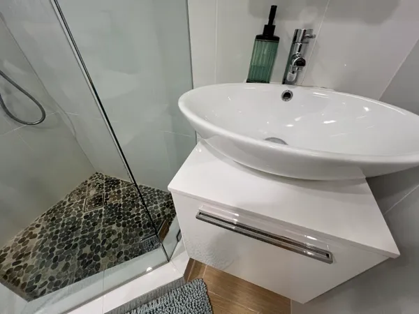 a view of a patio with table and chairs potted plants