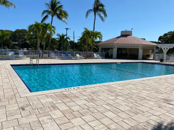 a view of swimming pool with outdoor seating and plants