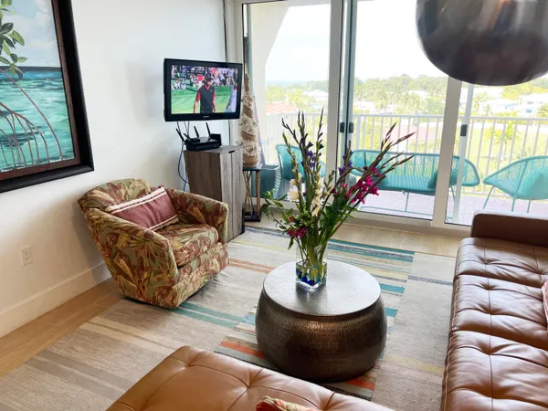 a kitchen with stainless steel appliances kitchen island granite countertop a refrigerator a stove a sink dishwasher and white cabinets with wooden floor