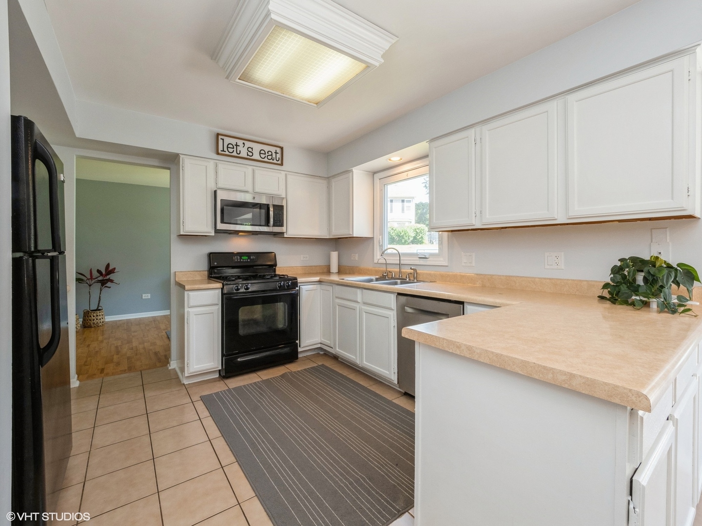 35 Crompton Court Fox River Grove, IL 60021 - Photo 7 of 39 a kitchen with granite countertop a stove top oven a sink dishwasher and a refrigerator with wooden floor