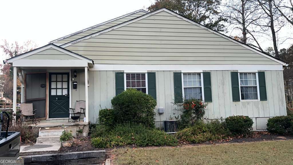 a view of a white house next to a yard