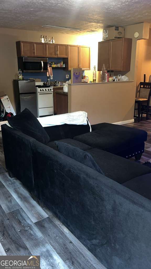 1341 Old Coach Road Southwest Marietta, GA 30008 - Photo 3 of 7 a living room with lots of appliances and wooden floor