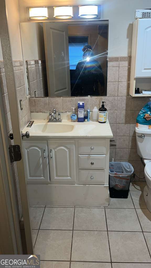1341 Old Coach Road Southwest Marietta, GA 30008 - Photo 6 of 7 a bathroom with a toilet sink and mirror
