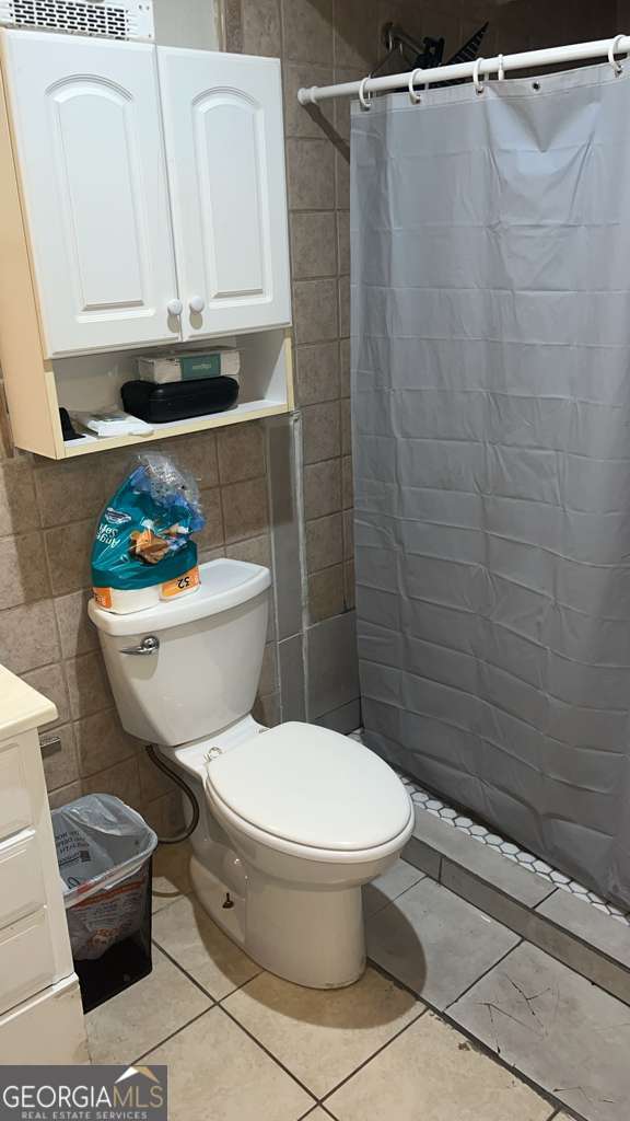 1341 Old Coach Road Southwest Marietta, GA 30008 - Photo 7 of 7 a bathroom with a toilet a sink and a shower