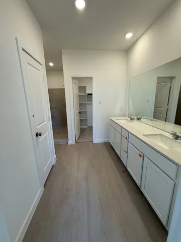 a white kitchen with a sink and cabinets