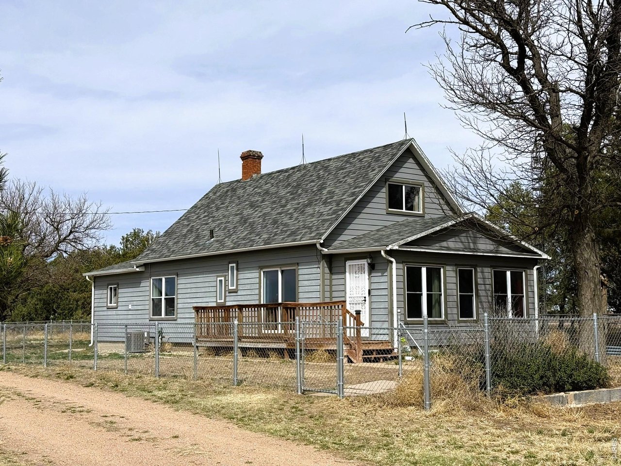 1935 County Road 75 Fleming, CO 80728 - Photo 1 of 31 a front view of a house with garden