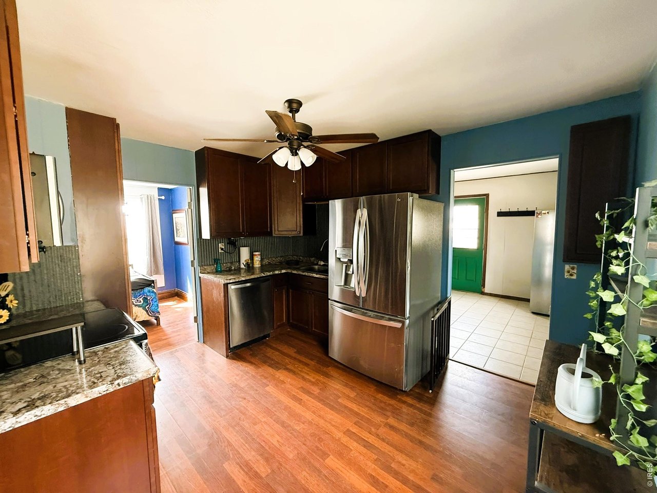 1935 County Road 75 Fleming, CO 80728 - Photo 13 of 31 a kitchen with granite countertop stainless steel appliances a sink cabinets and counter space