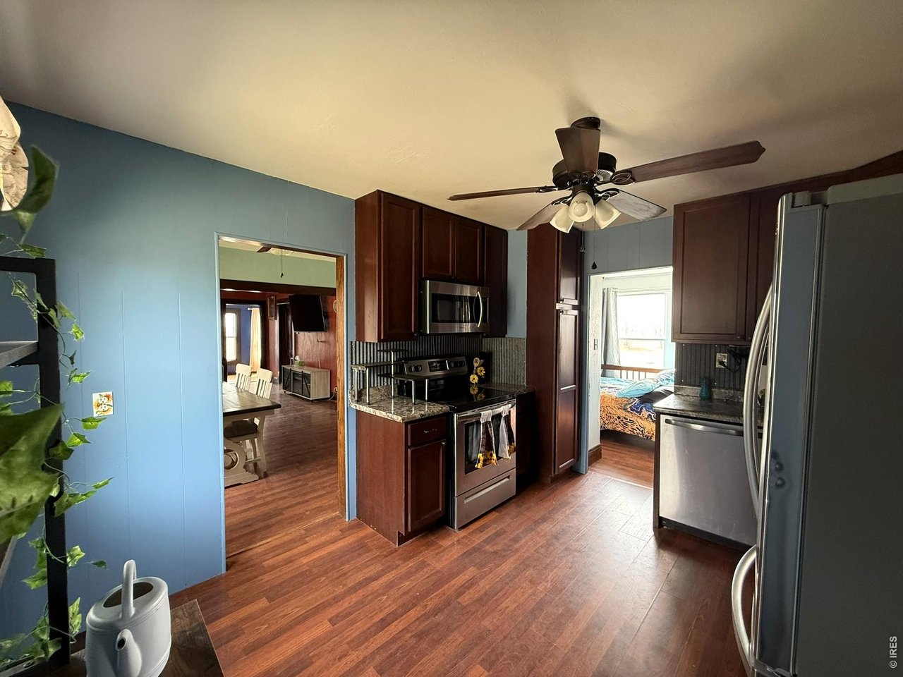 1935 County Road 75 Fleming, CO 80728 - Photo 15 of 31 a kitchen with wooden floors and stainless steel appliances