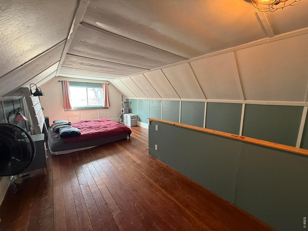 1935 County Road 75 Fleming, CO 80728 - Photo 19 of 31 a bedroom with a bed and wooden floor