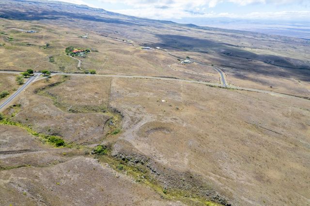 a view of a dry yard with wooden fence