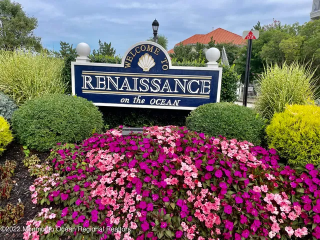 a sign that is sitting in front of flowers