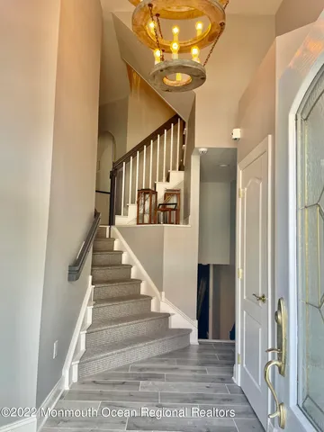 a view of entryway and hall with wooden floor