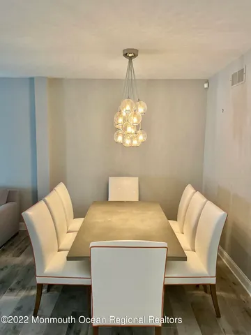 a living room with a couch and a chandelier
