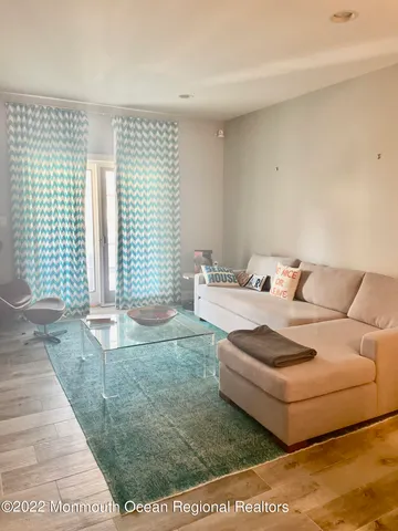 a living room with furniture and a rug