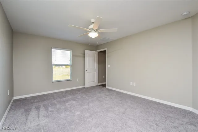 a bathroom with a granite countertop sink a mirror and a shower