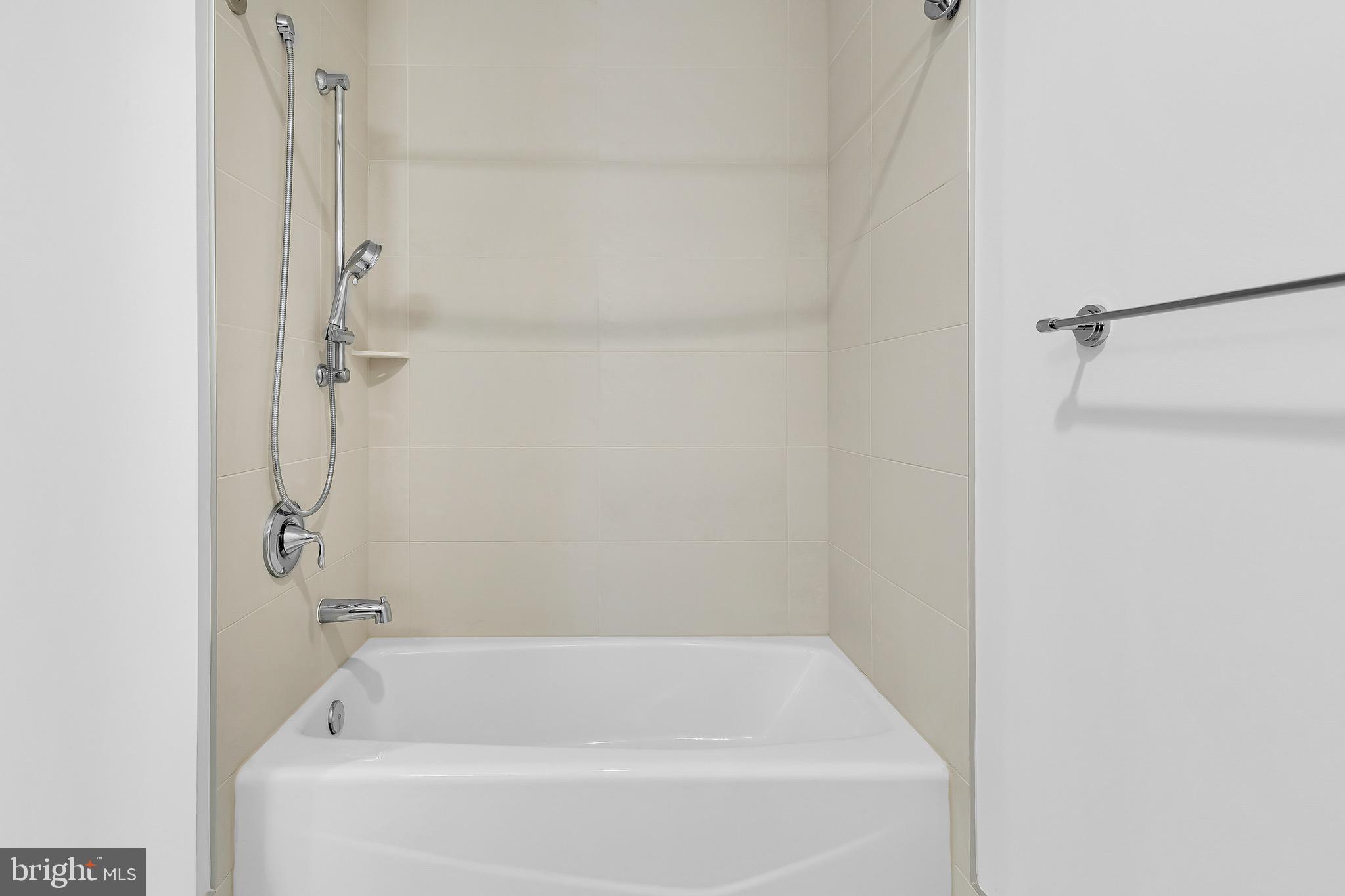 880 New Jersey Avenue Southeast, Unit STUDIO Washington, DC 20003 - Photo 11 of 24 a bathroom with a bathtub