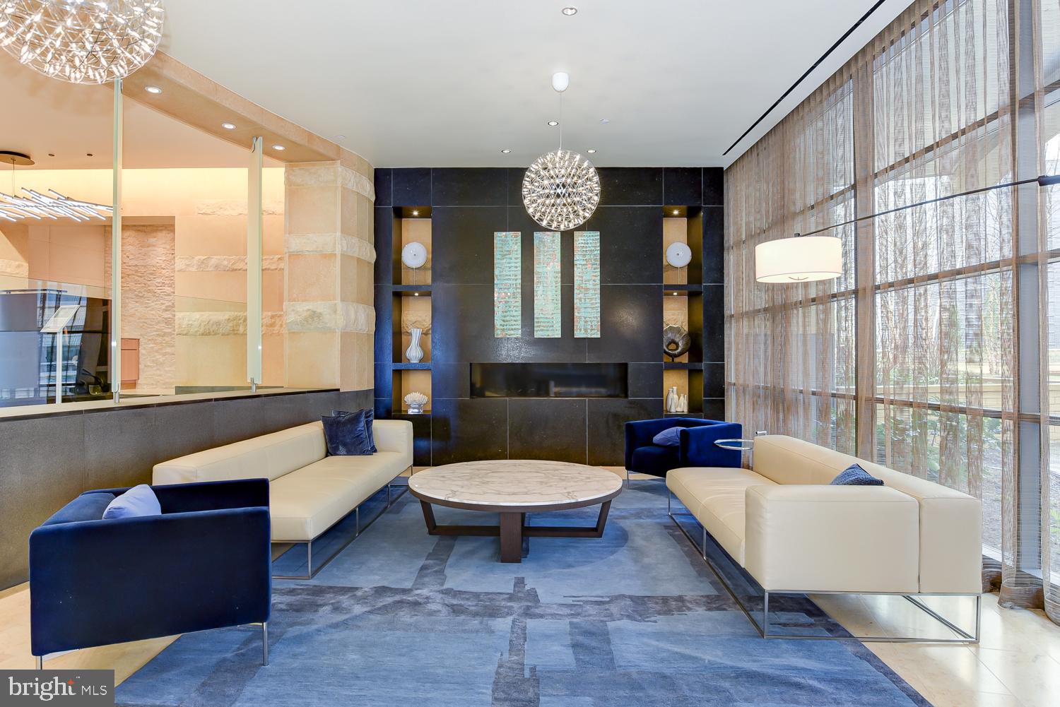 880 New Jersey Avenue Southeast, Unit STUDIO Washington, DC 20003 - Photo 13 of 24 a living room with furniture a large window and wooden floor