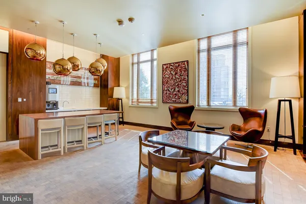 a dining room with furniture and a large window