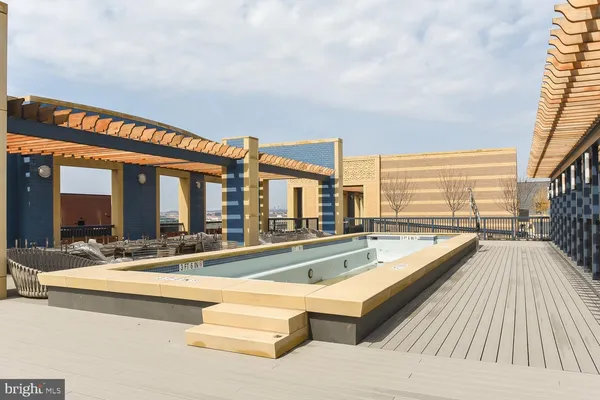 a view of house with swimming pool and furniture