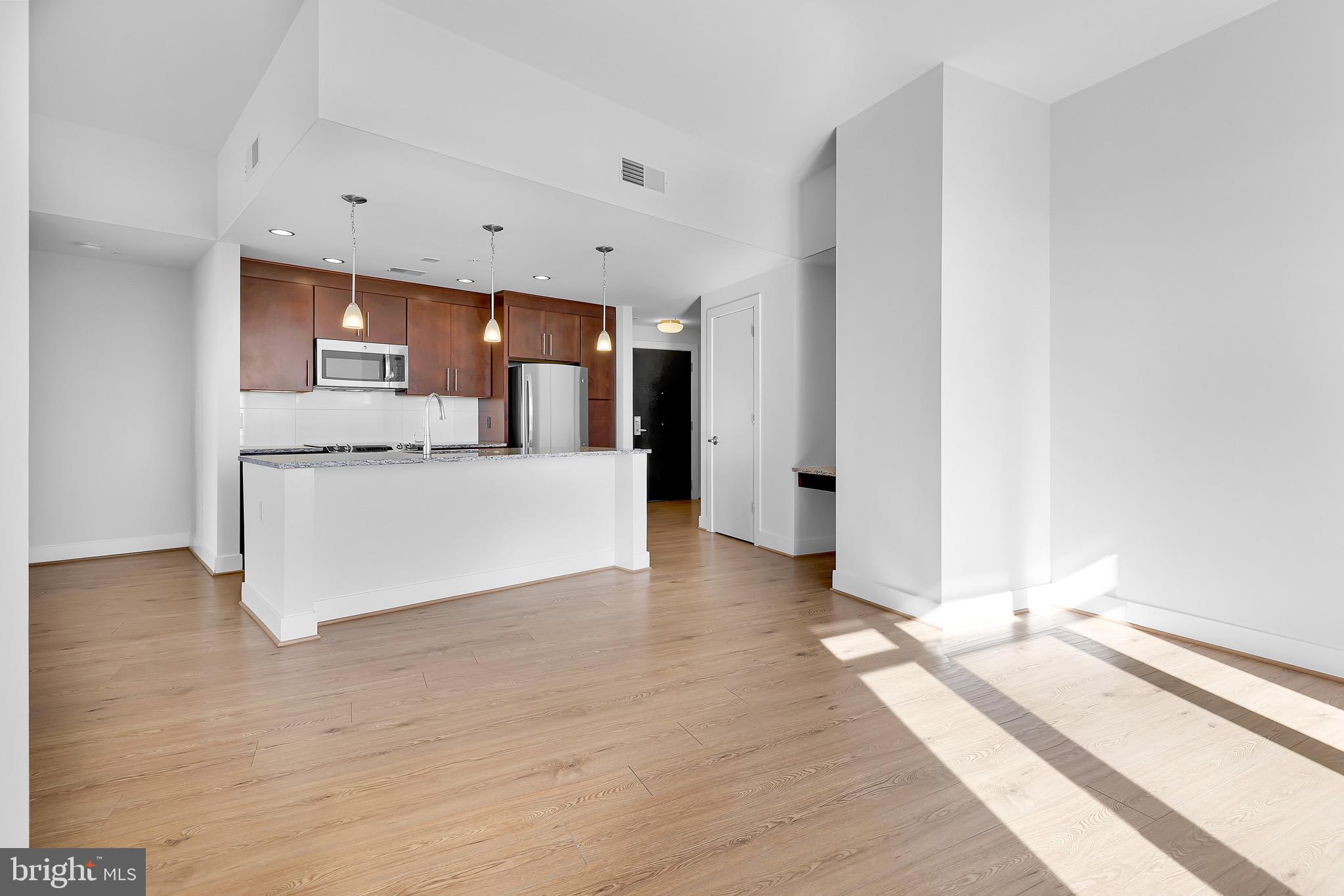 880 New Jersey Avenue Southeast, Unit STUDIO Washington, DC 20003 - Photo 5 of 24 a view of a kitchen with a sink and a large window