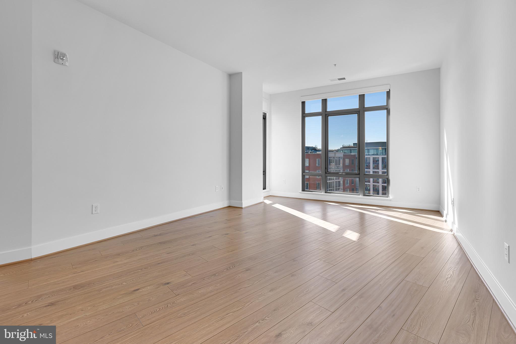 880 New Jersey Avenue Southeast, Unit STUDIO Washington, DC 20003 - Photo 6 of 24 wooden floor in an empty room with a window