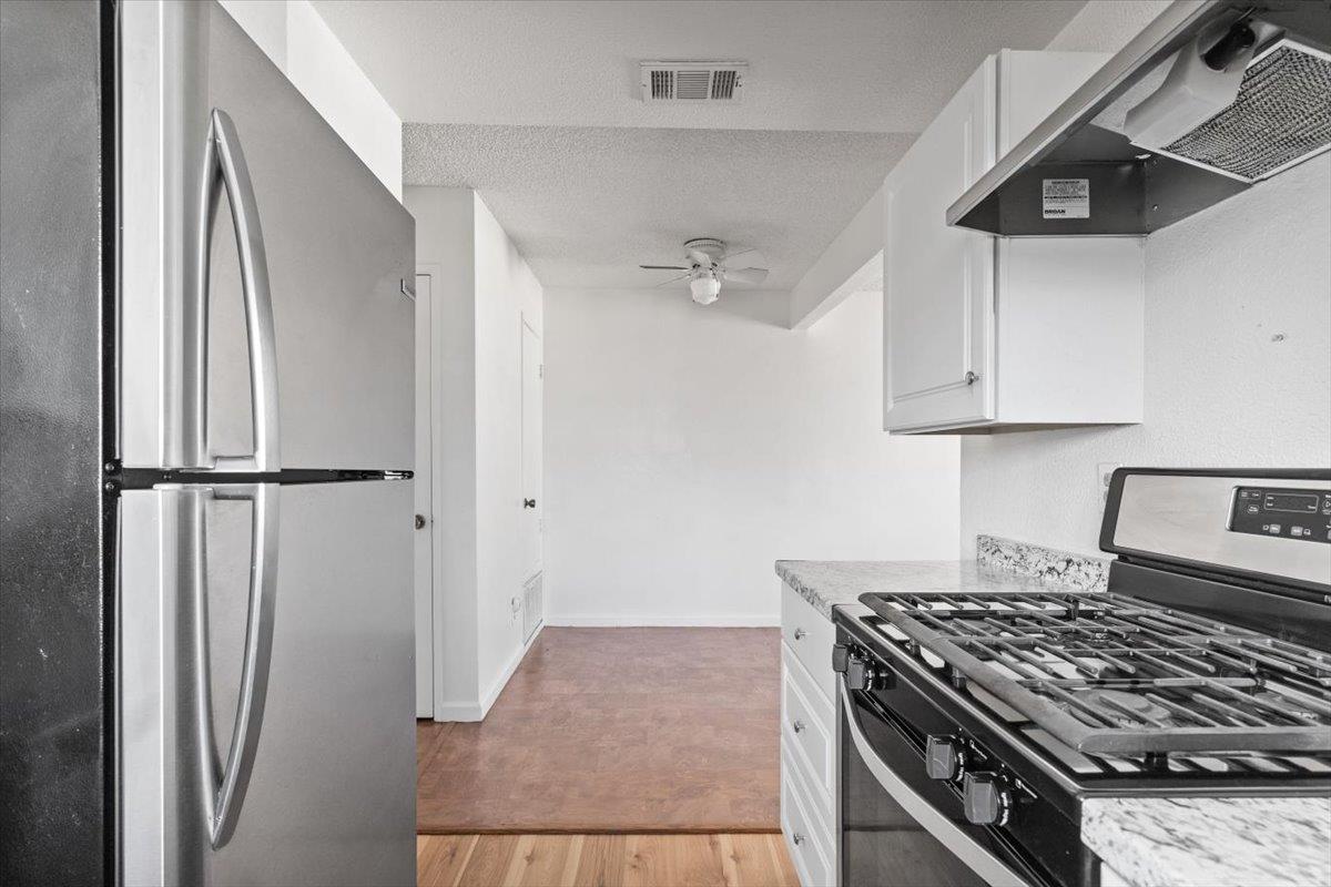 11570 Garnet Way, Unit 4 Auburn, CA 95602 - Photo 11 of 44 a kitchen with stainless steel appliances granite countertop a refrigerator and a stove top oven