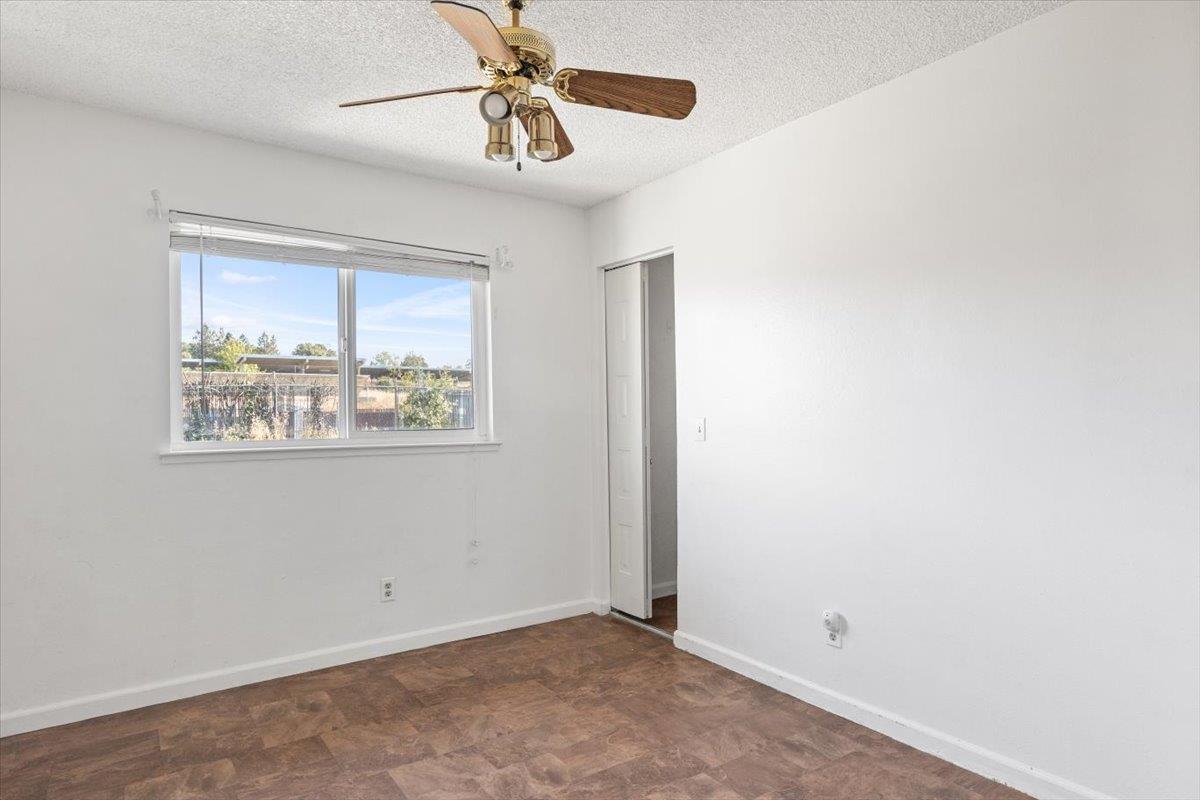 11570 Garnet Way, Unit 4 Auburn, CA 95602 - Photo 13 of 44 an empty room with a window and a fan