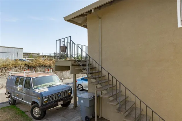 a view of house with backyard and outdoor seating