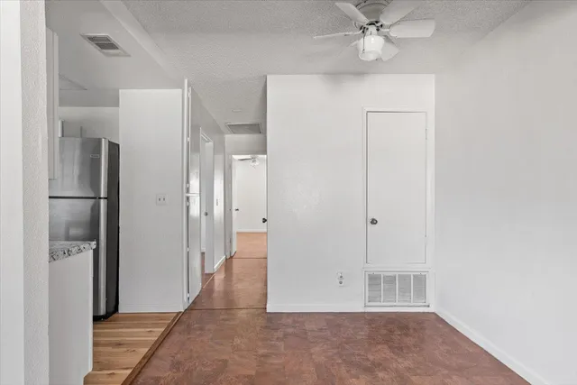 a kitchen with refrigerator and cabinets