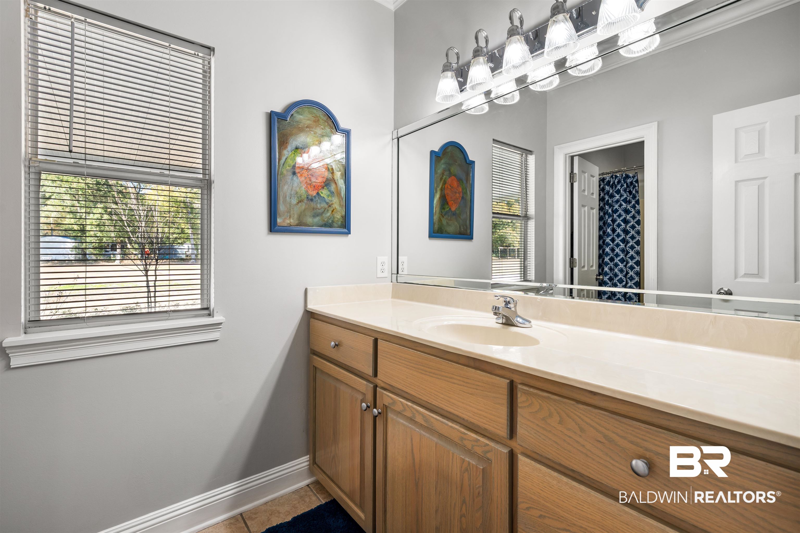 19079 Baldwin County Road 10 Foley, AL 36535 - Photo 16 of 37 Bathroom with vanity, a shower with shower curtain, and light tile patterned floors