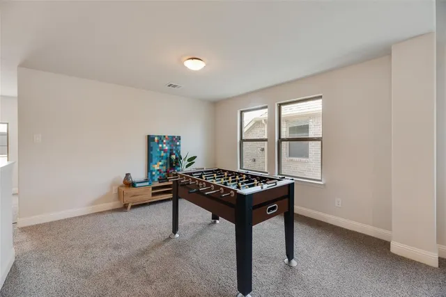 a living room with furniture and flowers